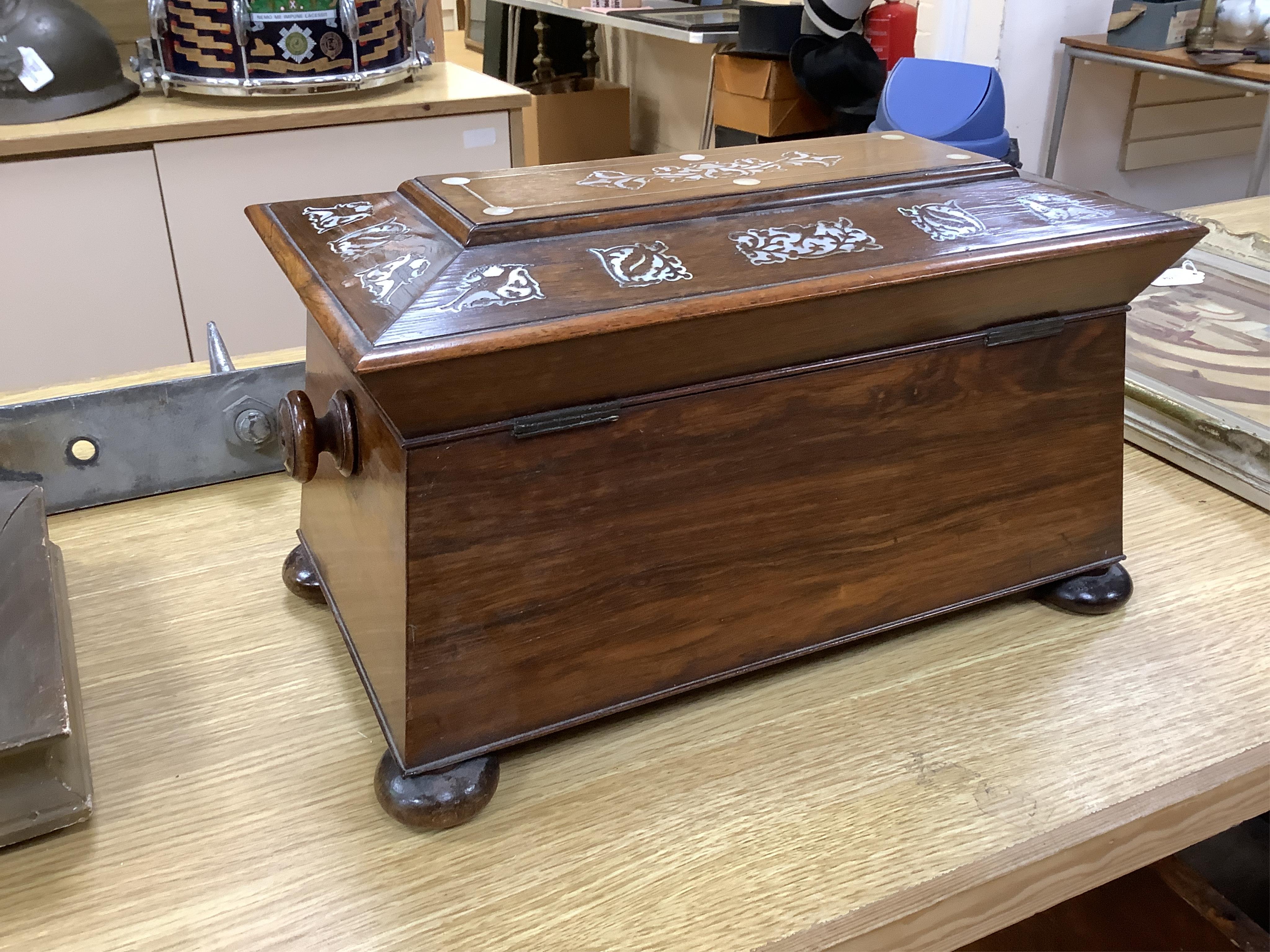 A Victorian rosewood and mother-of-pearl inlaid sarcophagus tea caddy, 39cm wide. Condition - fair